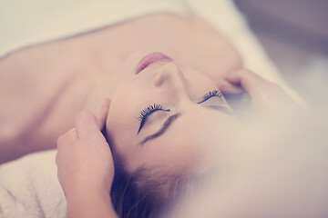 Image showing woman getting face and head  massage in spa salon