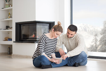 Image showing Young Couple using digital tablet on cold winter day