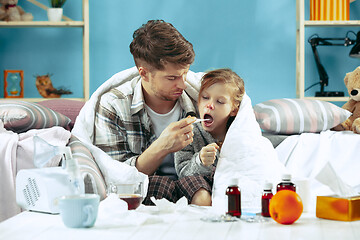 Image showing Sick man with daughter at home. The ill family.