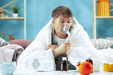 Image showing Bearded sick man with flue sitting on sofa at home. Illness, influenza, pain concept. Relaxation at Home. Healthcare Concepts.