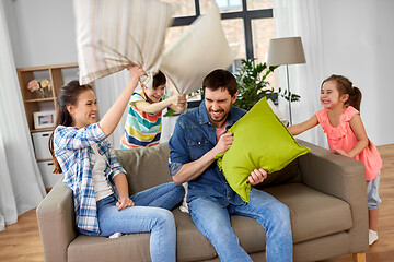 Image showing happy family having pillow fight at home