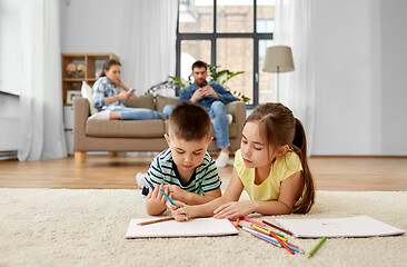 Image showing brother and sister drawing with crayons at home