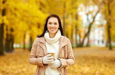 Image showing woman drinking takeaway coffee in autumn park