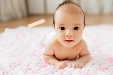 Image showing sweet baby girl lying on knitted plush blanket