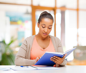 Image showing african american female student reading book