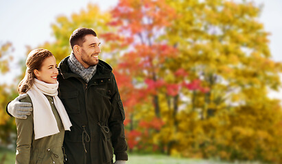 Image showing smiling couple hugging in autumn park