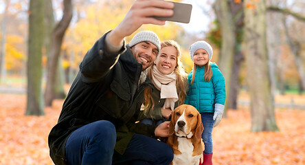 Image showing happy family with dog taking selfie in autumn park