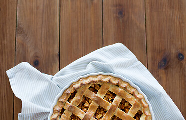 Image showing close up of apple pie in mold on wooden table