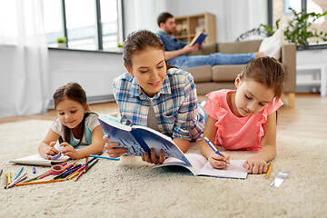 Image showing mother spending time with little daughters at home