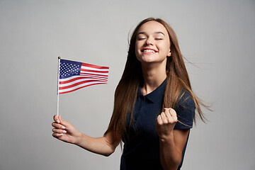 Image showing Happy female holding USA flag
