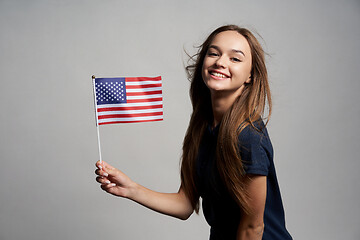 Image showing Happy female holding USA flag