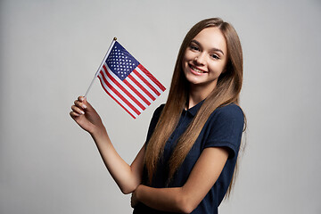 Image showing Happy female holding United States flag