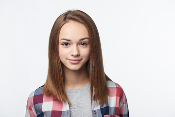 Image showing Smiling relaxed teen girl looking at camera