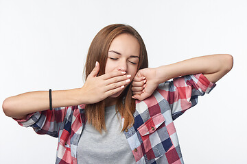 Image showing Tired woman yawning covering a mouth with her hand