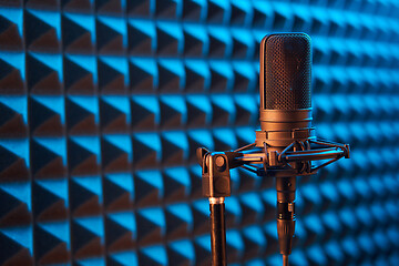 Image showing Studio condenser microphone on blue acoustic foam panel background