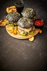 Image showing Delicious black hamburger with patties and cheese
