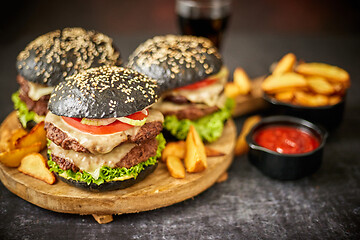 Image showing Delicious black hamburger with patties and cheese