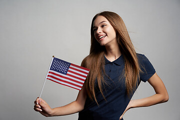 Image showing Happy female holding United States flag