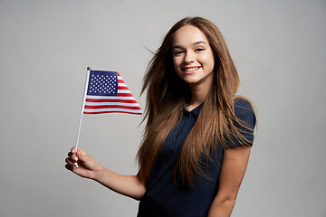 Image showing Happy female holding America flag