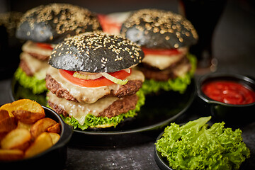 Image showing Delicious black hamburger with patties and cheese