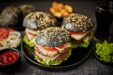Image showing Delicious black hamburger with patties and cheese