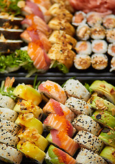 Image showing Close up of Various sushi set in black plastic delivery box. Top view