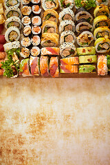 Image showing Wooden board with assortment of various kinds of sushi rolls. Japanese food concept