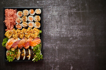 Image showing Sushi take-away plastic tray with diffent kinds of rolls and copy space. Take-away food concept.