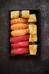 Image showing Nigiri sushi set in plastic container ready for takeout delivery. Closeup of take away lunch box