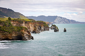 Image showing sea shore rocks and mount Taranaki, New Zealand