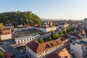 Image showing Aerial drone panoramic view of Ljubljana medieval city center, capital of Slovenia in warm afternoon sun. Empty streets during corona virus pandemic social distancing measures