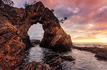 Image showing Morning sunrise at dramatic sea arch cave