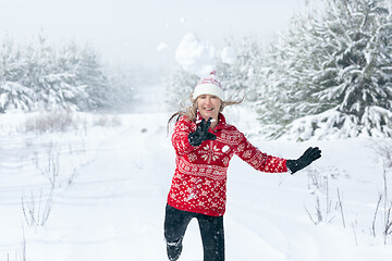 Image showing Snowball flying through the air as it leaves womans hands