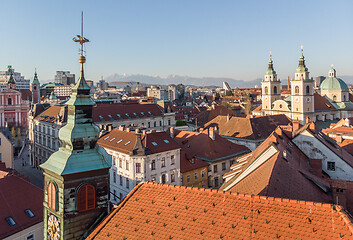 Image showing Scenic panoramic aerial drone view of rooftops of medieval city center, town hall and cathedral church in Ljubljana, capital of Slovenia, at sunset