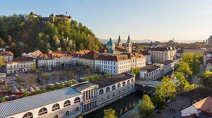 Image showing Aerial drone panoramic view of Ljubljana medieval city center, capital of Slovenia in warm afternoon sun. Empty streets during corona virus pandemic social distancing measures