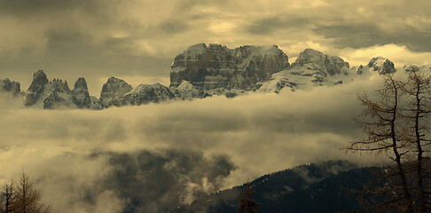 Image showing Snow-capped alps mountains in clouds