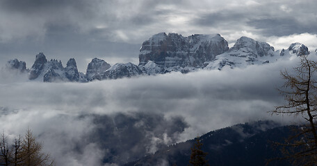 Image showing Snow-capped alps mountains in clouds