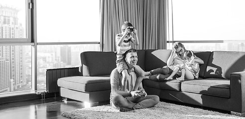 Image showing Happy family playing a video game