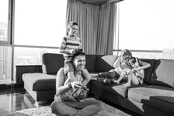 Image showing Happy family playing a video game