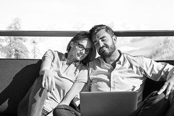 Image showing couple relaxing at  home using laptop computers