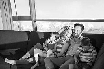 Image showing happy young couple spending time with kids at home