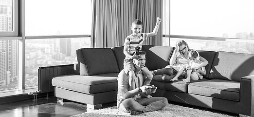 Image showing Happy family playing a video game