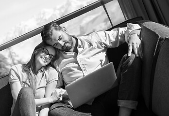 Image showing couple relaxing at  home using laptop computers