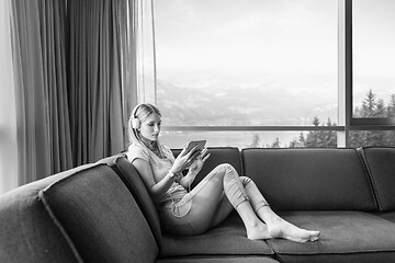 Image showing young girl enjoying music through headphones