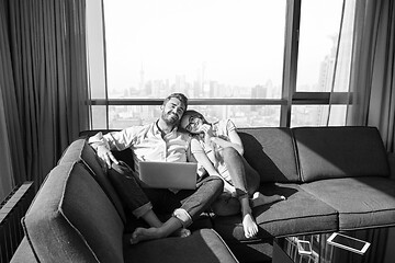 Image showing couple relaxing at  home using laptop computers