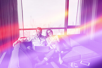 Image showing couple relaxing at  home using laptop computers