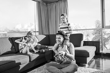 Image showing Happy family playing a video game