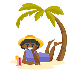 Image showing African woman lying on the beach under the palm.