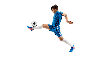 Image showing Young boy with soccer ball doing flying kick