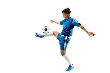 Image showing Young boy with soccer ball doing flying kick